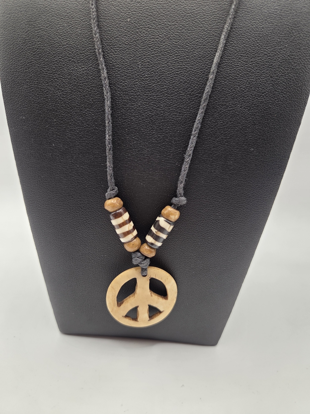 1689. Carved Bone Peace Sign Pendant Necklace On A Leather Cord